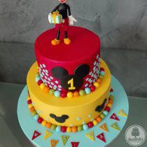 Tort cu Șoricelul Mickey - Mickey Mouse cu un cadou în mână, capul lui Mickey 2D și nunumărate steluțe bleu și bile colorate: roșii, bleu, verzi, portocalii și galbene